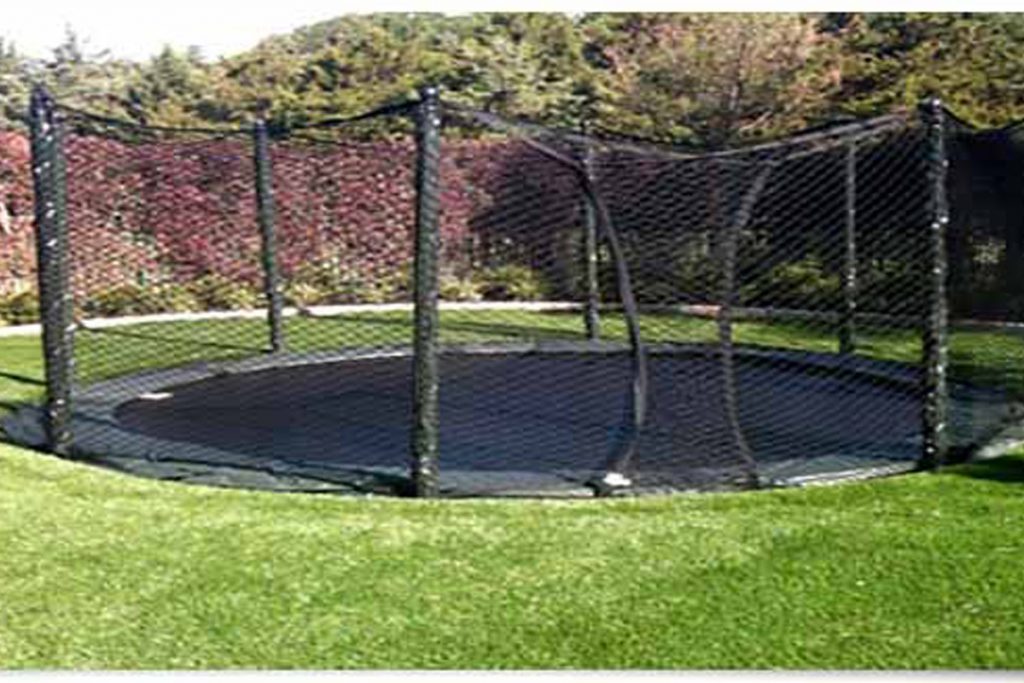 Green Trampoline On The Lawn In Garden Closeup Empty Children T